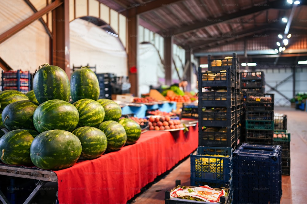 a table filled with lots of watermelons and other fruits