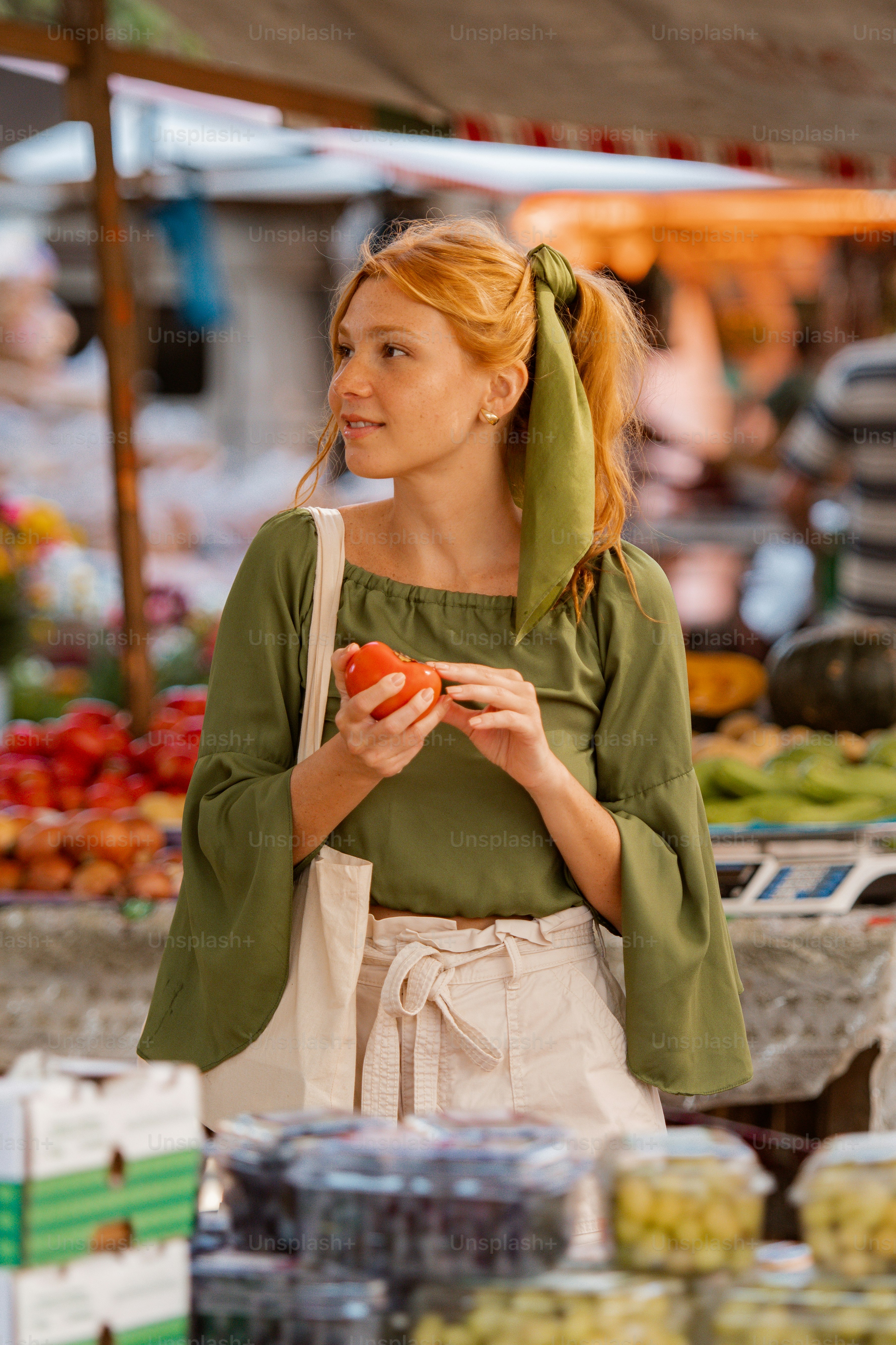 A woman standing in front of a fruit stand photo – Shopping Image on ...
