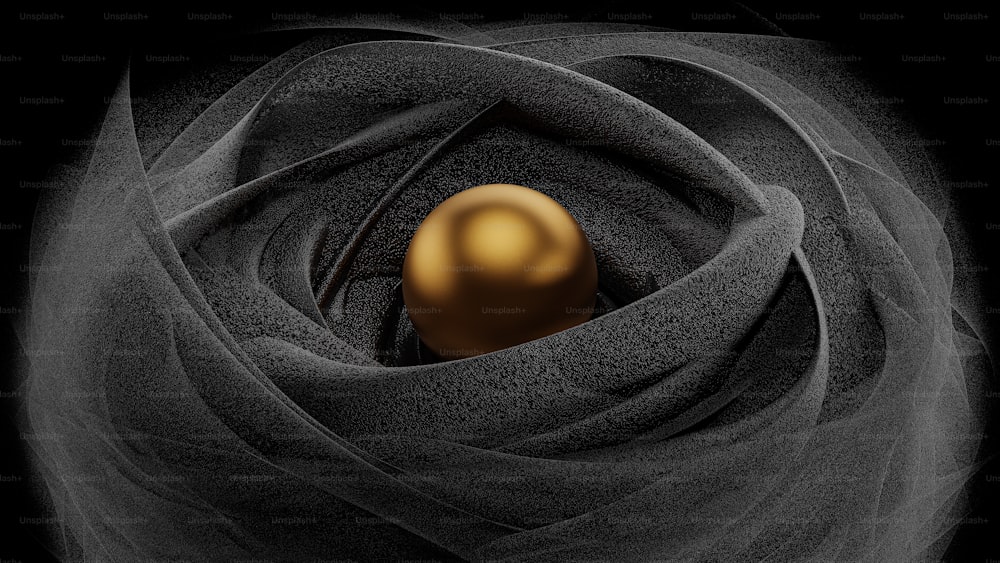 a black and gold scarf with a gold ball in it