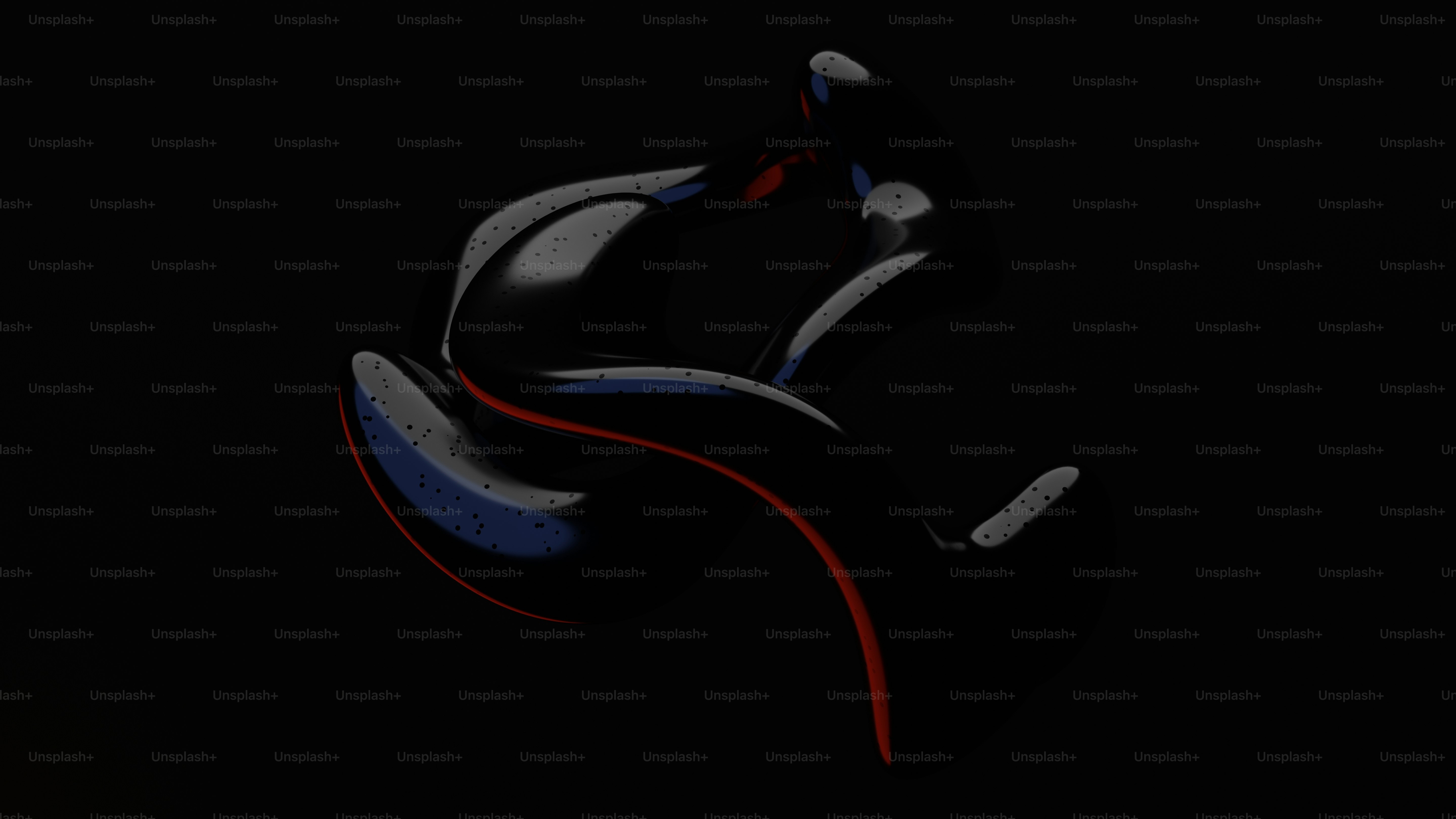 a pair of black and red shoes on a black background