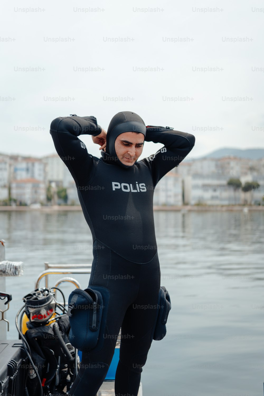 a man in a wet suit standing next to a boat