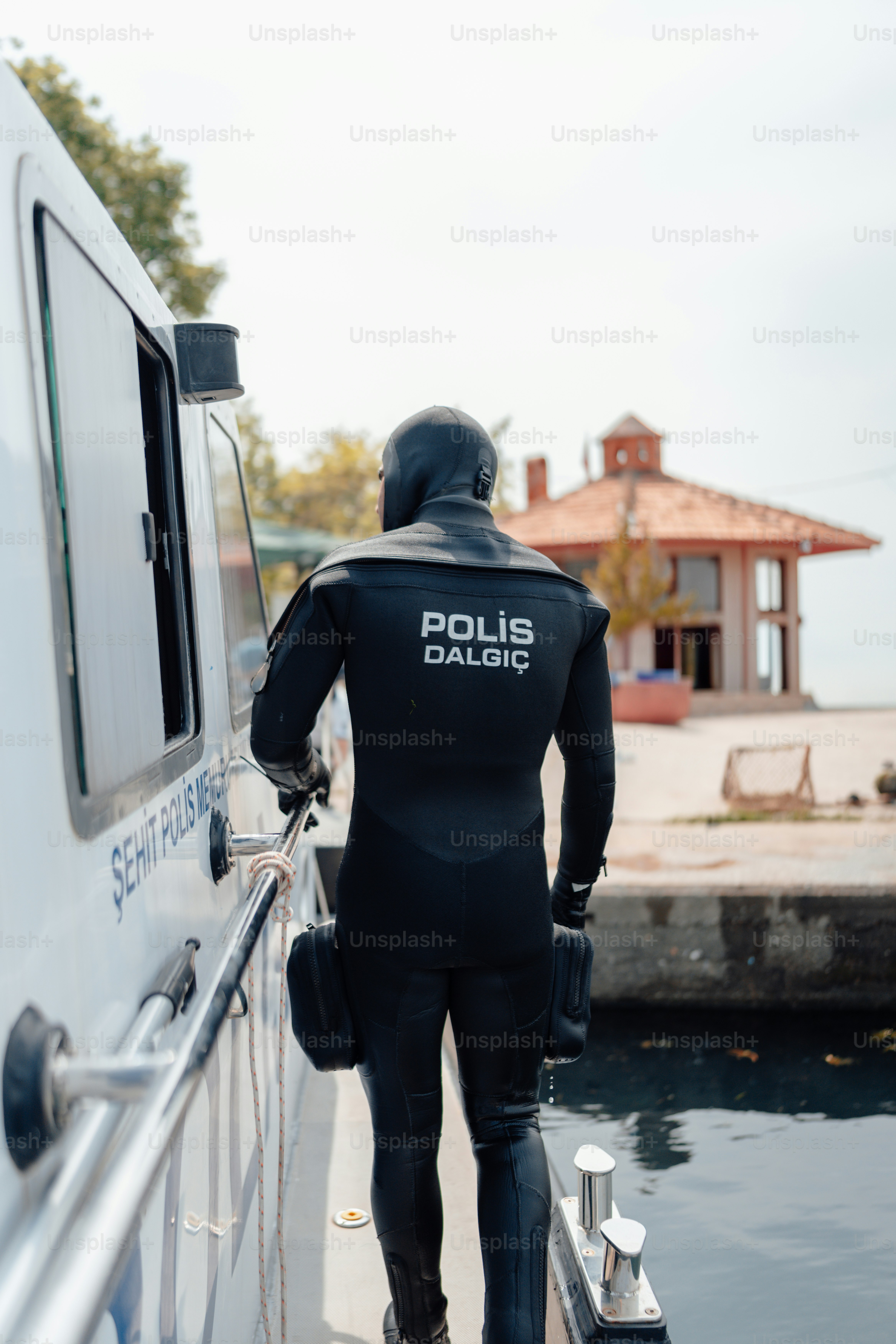 a man in a wet suit standing on a boat