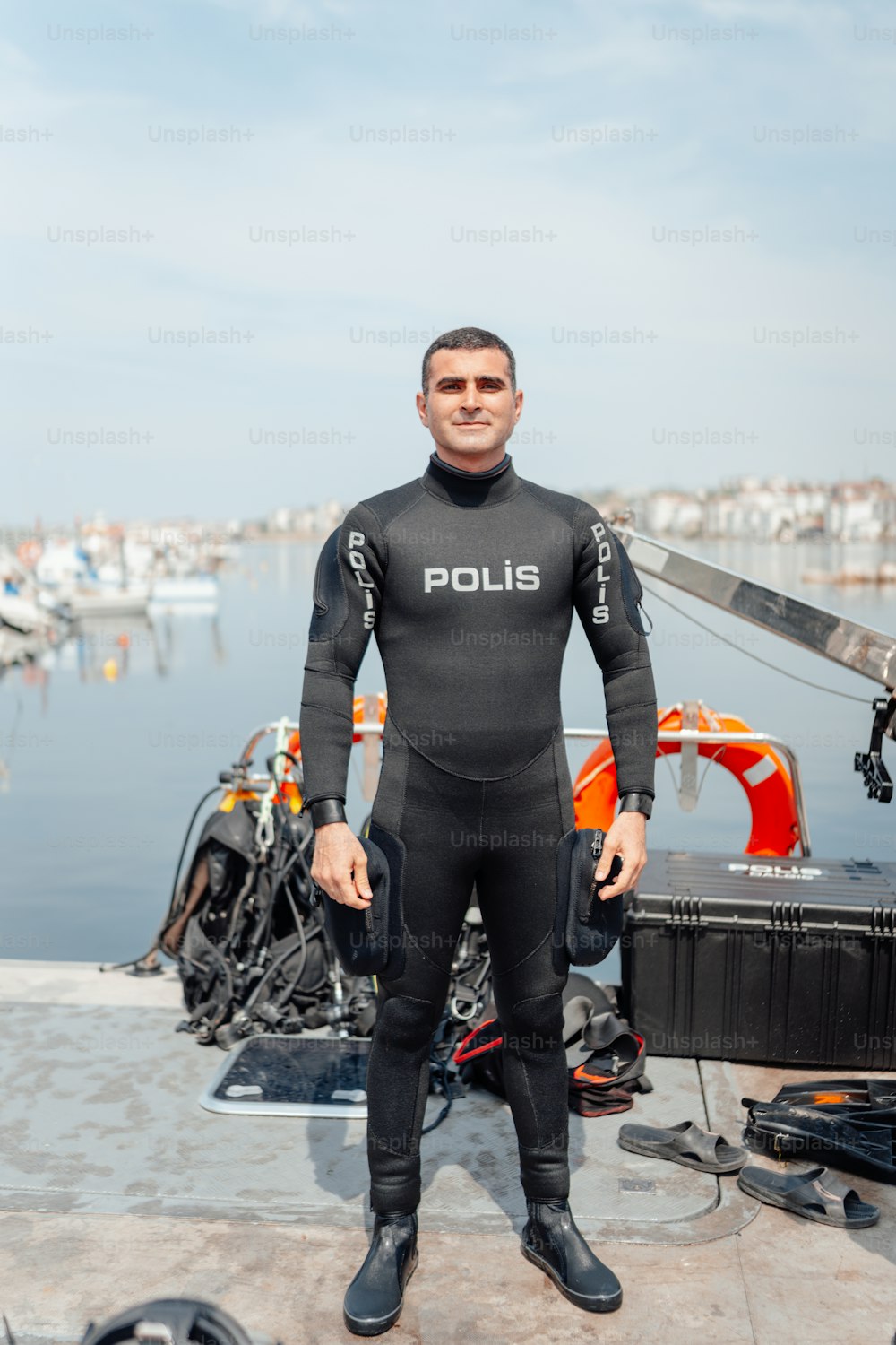 a man in a wet suit standing on a dock