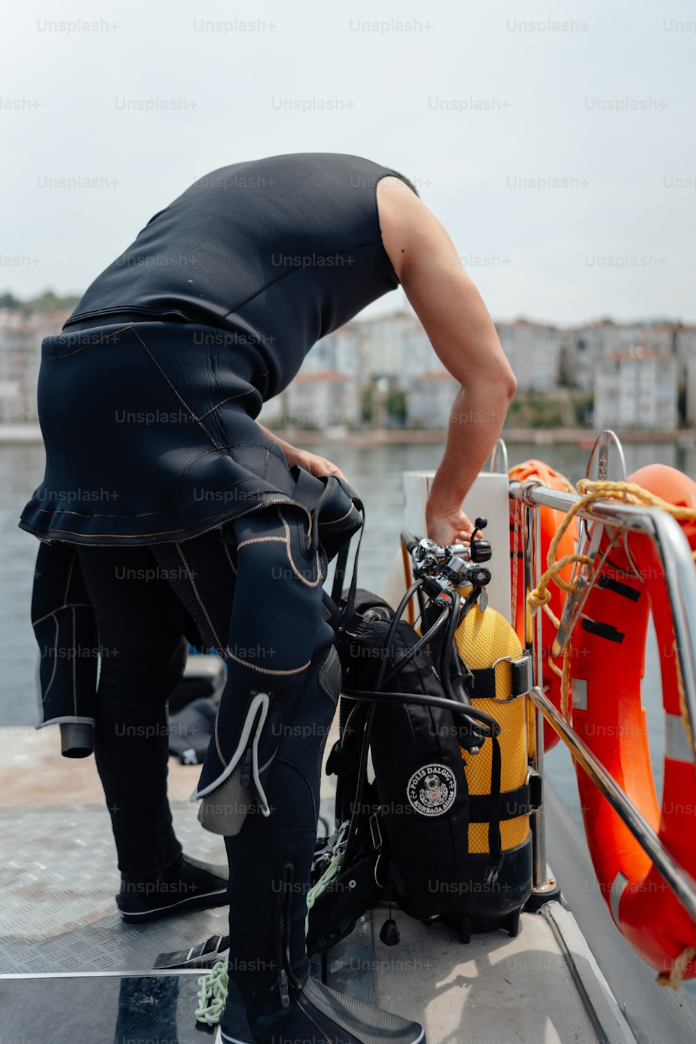 a man standing on a boat next to a life preserver