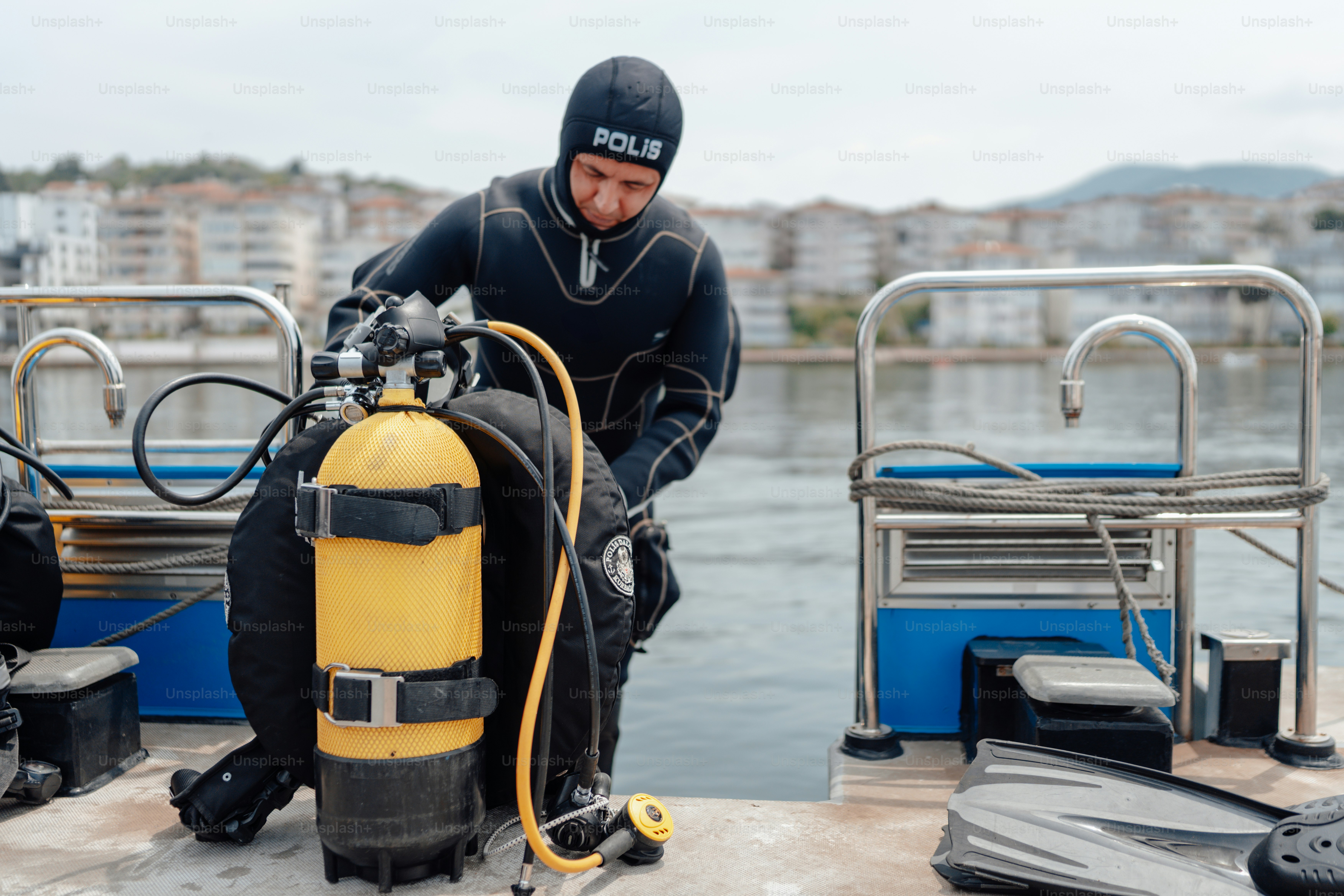 a man in a wet suit is standing on a boat