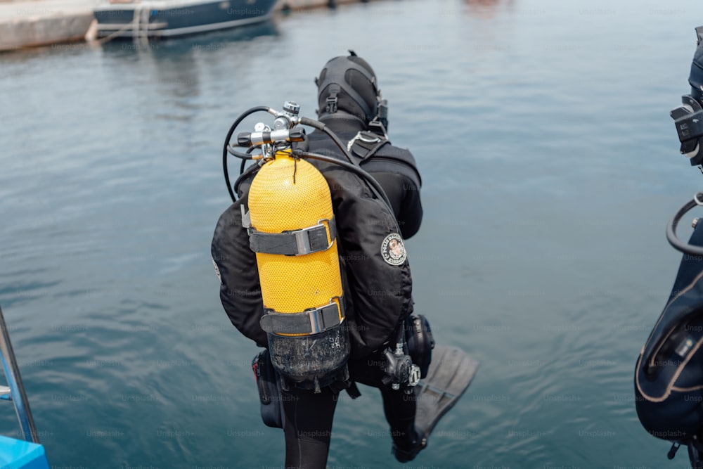 Uma pessoa em um traje de mergulho está de pé em um dispositivo de mergulho