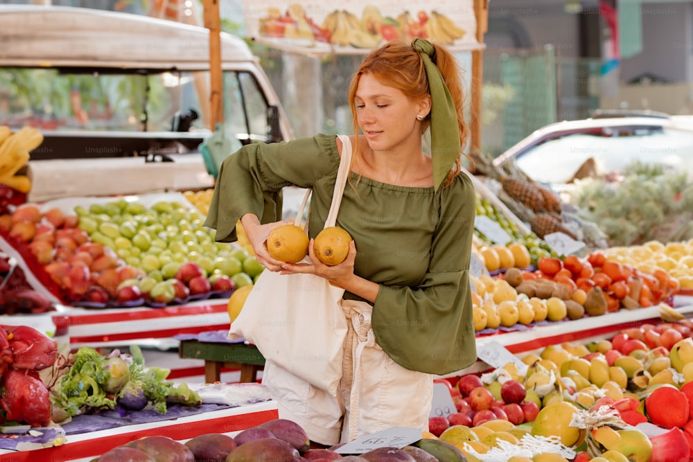 a woman in a green top is shopping for fruit