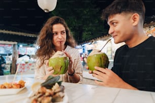 a man and a woman sitting at a table eating food