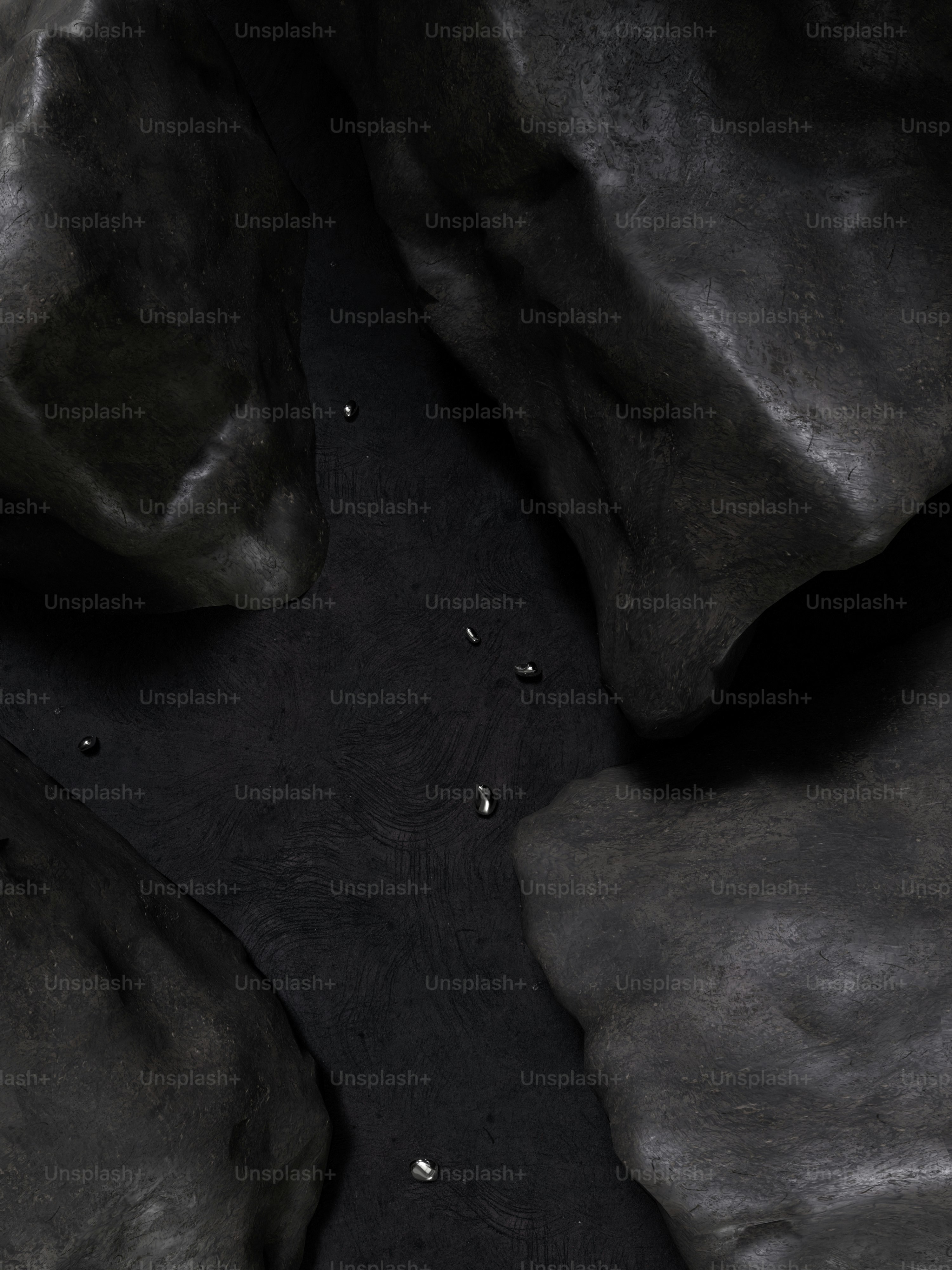 a black and white photo of rocks and water