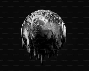 a black and white photo of a ball with icicles on it
