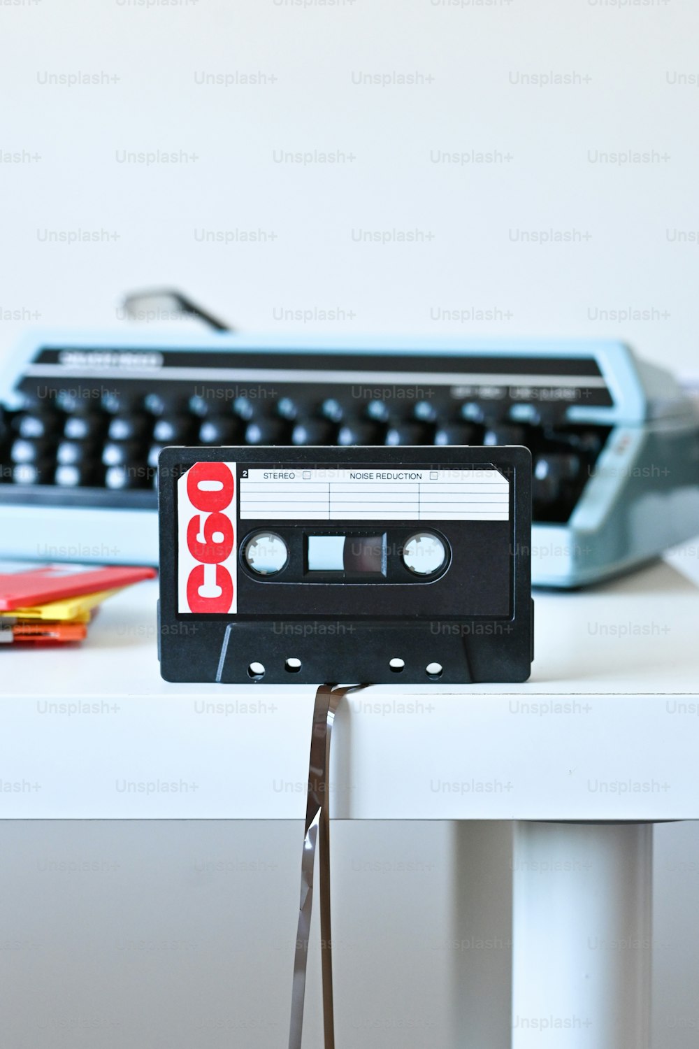 an old fashioned cassette player sitting on a table next to a typewriter
