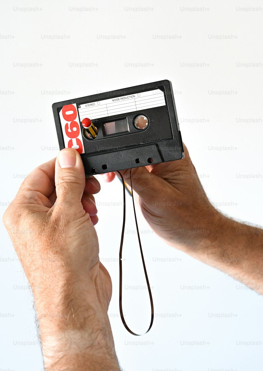 a person holding a tape recorder in their hand