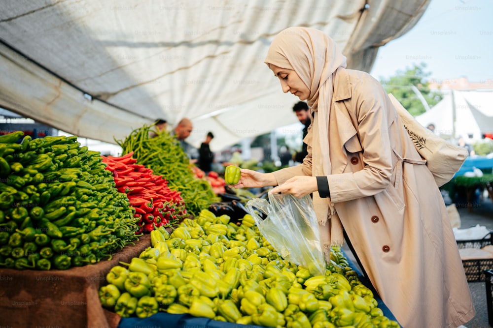 Una mujer con un hijab comprando verduras