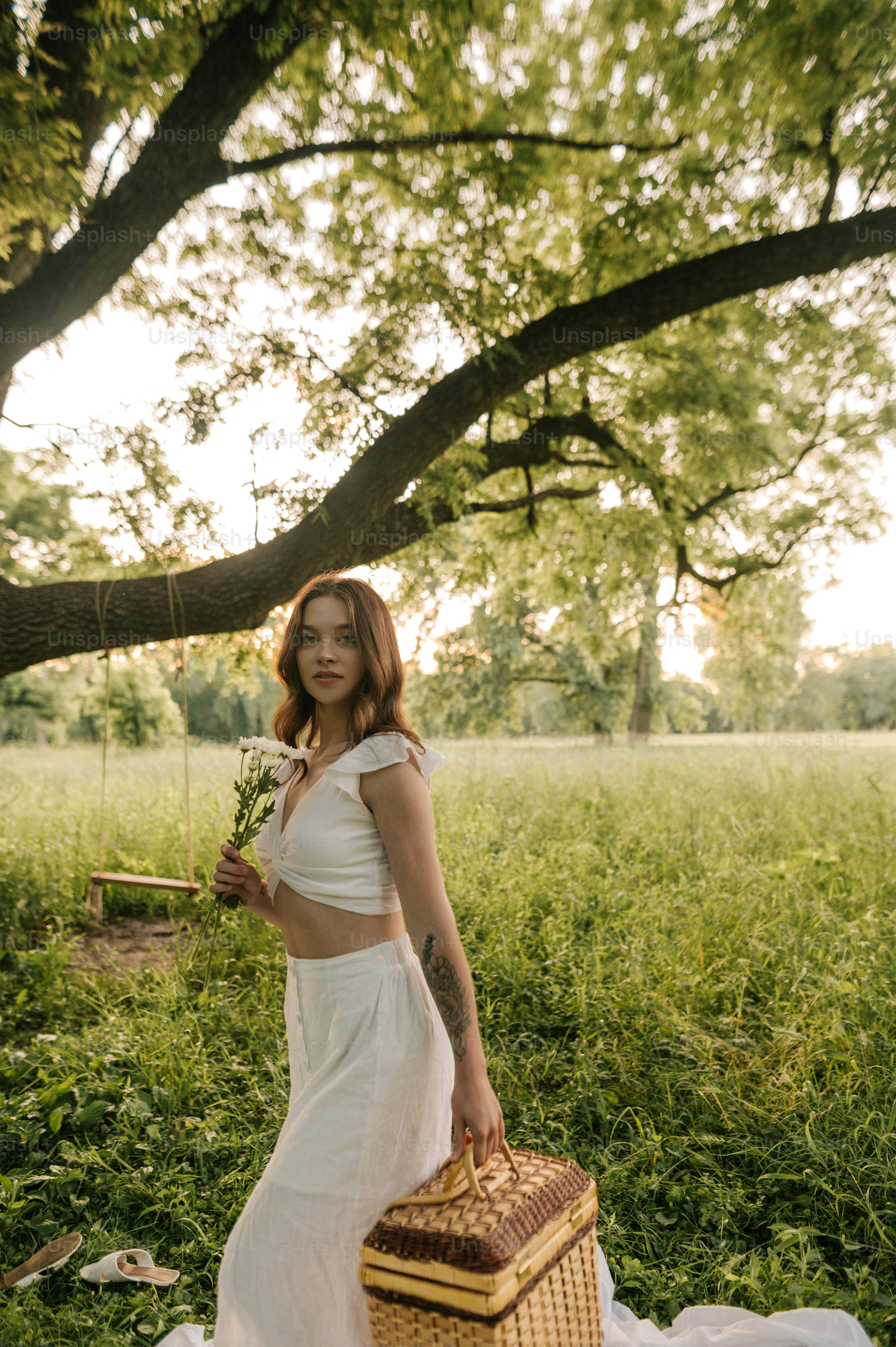 A woman in a white dress standing in a field photo – Gen z Image on ...