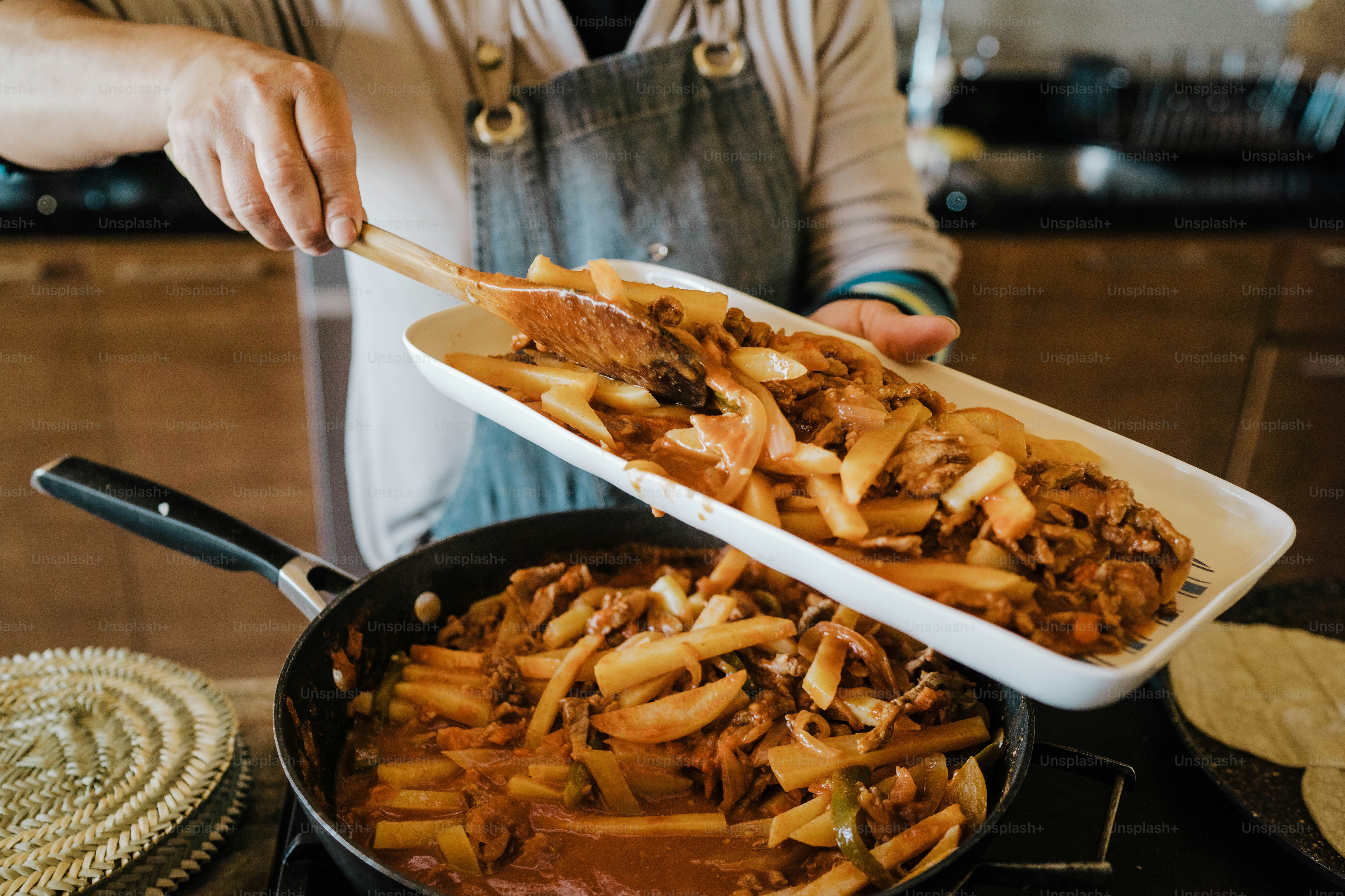 A person stirring food in a bowl on a stove photo – Food Image on Unsplash