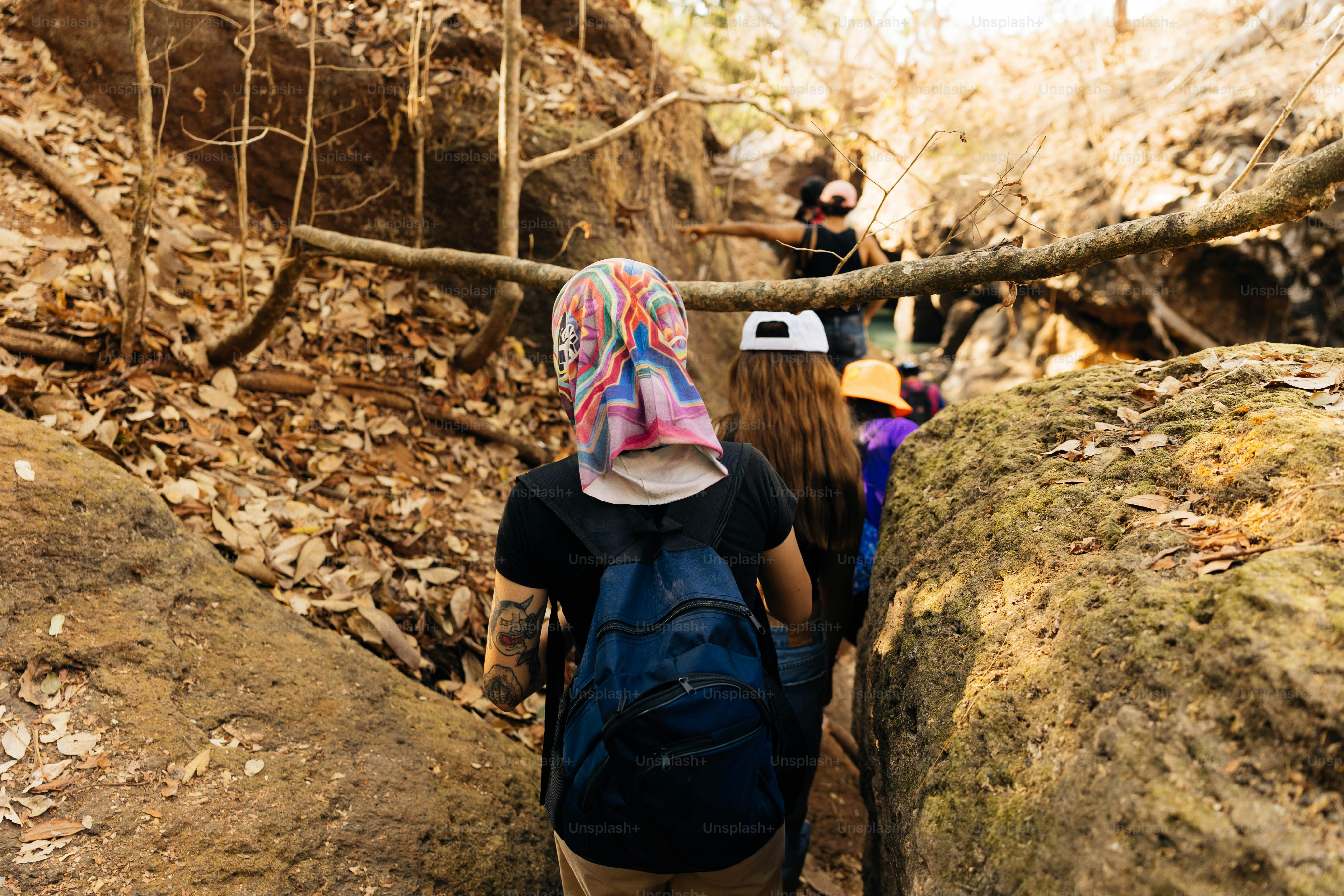 a group of people hiking up a rocky trail