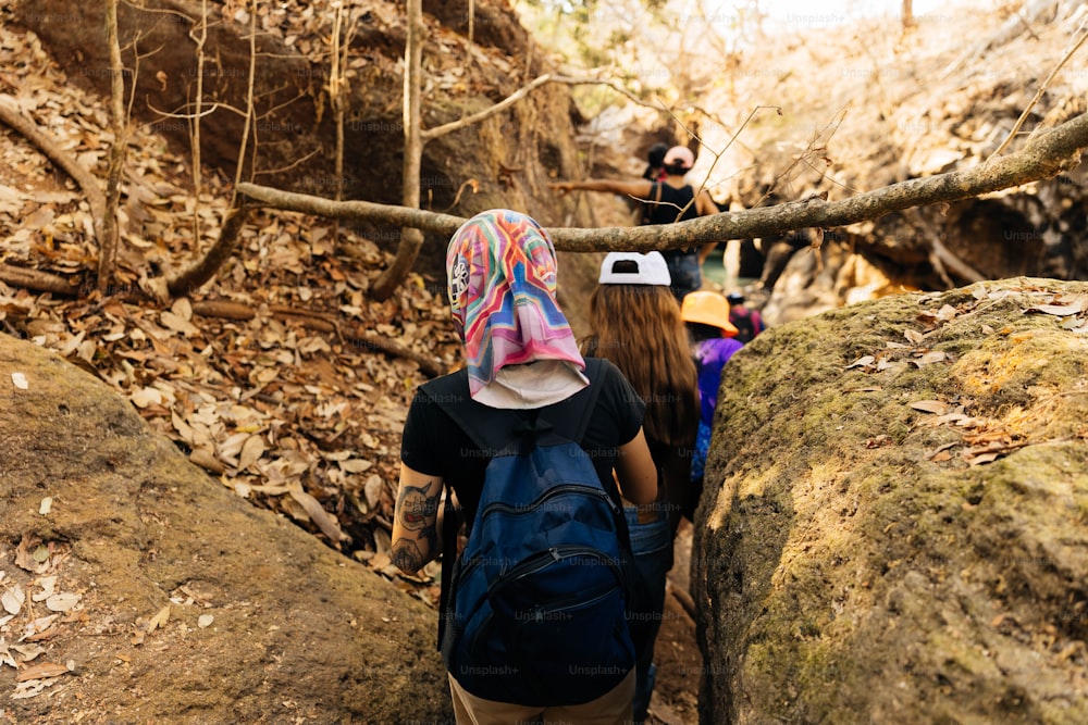a group of people hiking up a rocky trail