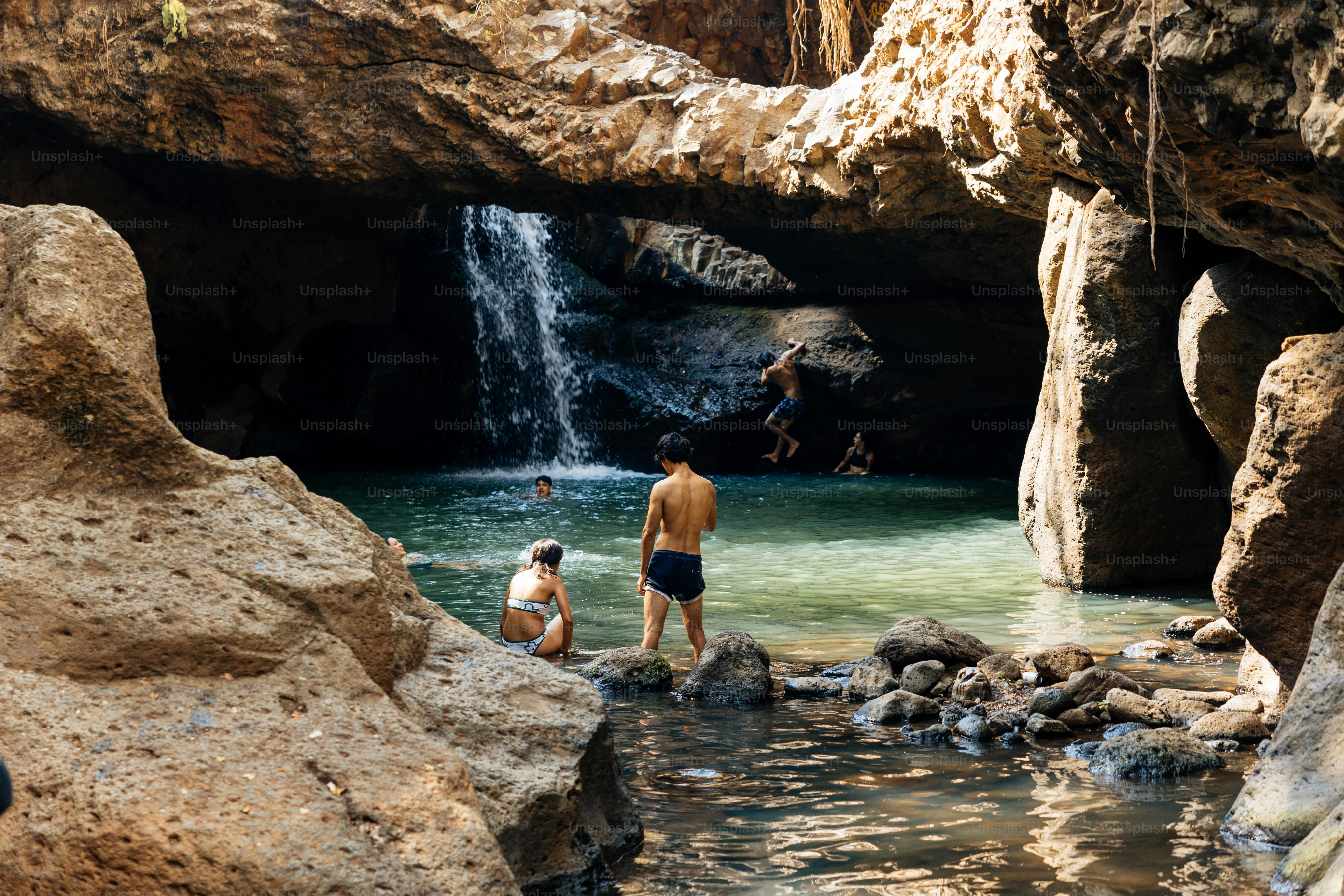 a couple of people that are standing in the water