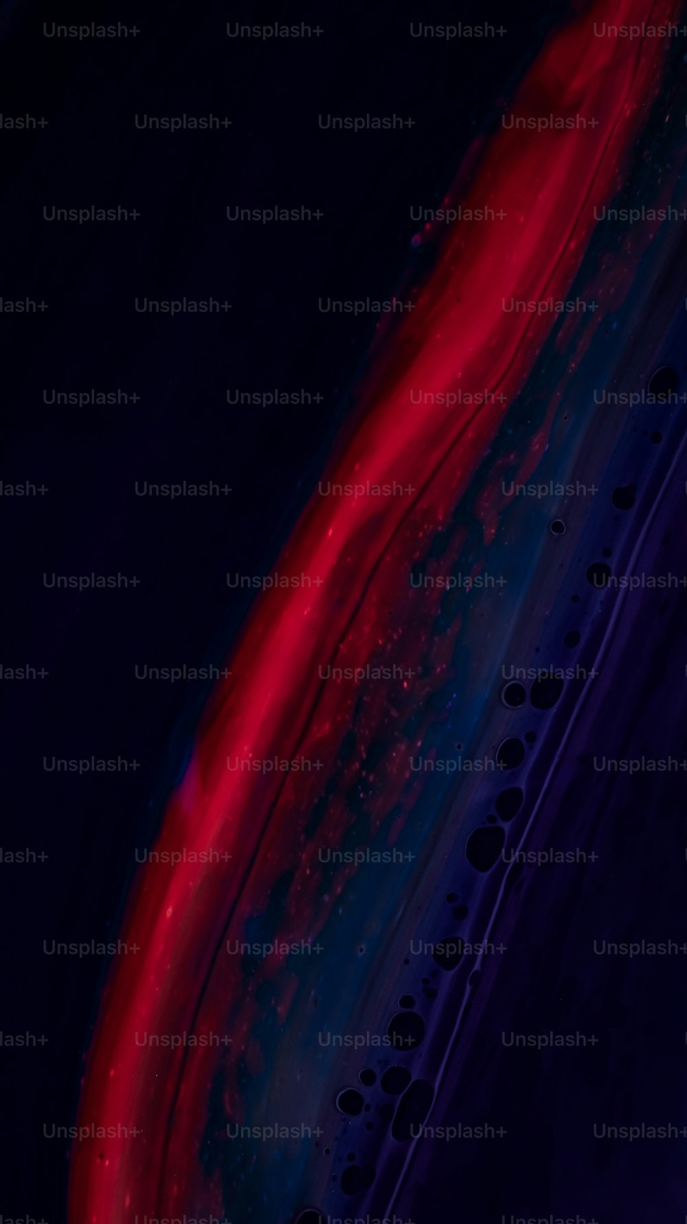 a close up of a cell phone with a red and blue background