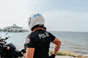 a police officer standing next to a motorcycle