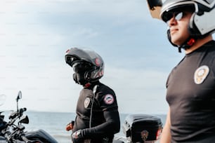 a man standing next to a woman on a motorcycle