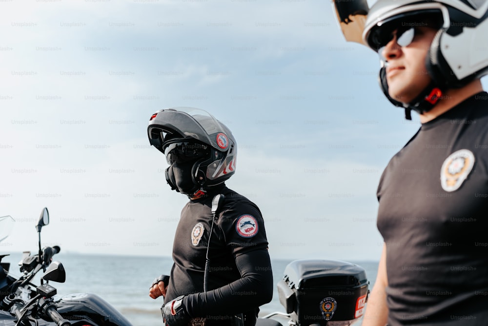 a man standing next to a woman on a motorcycle