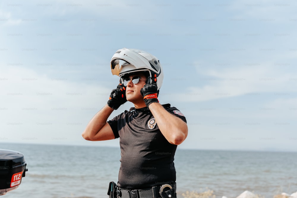 a man wearing a helmet while talking on a cell phone
