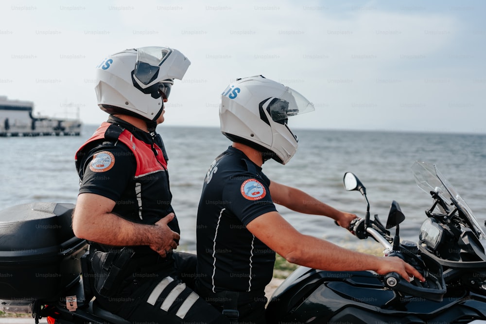 a couple of men riding on the back of a motorcycle