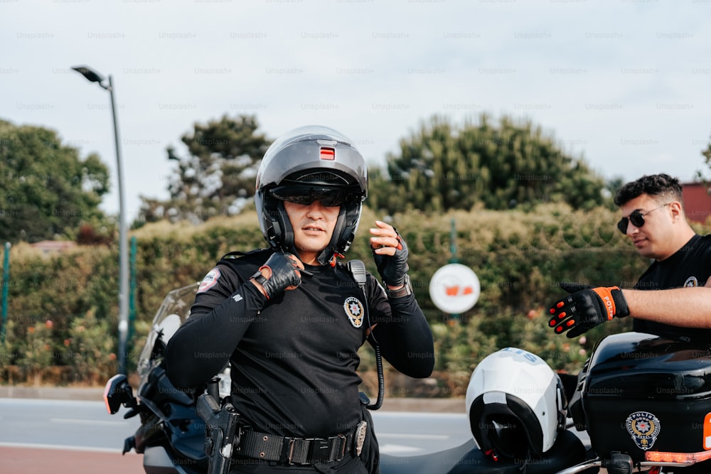 a man in a police uniform standing next to a motorcycle