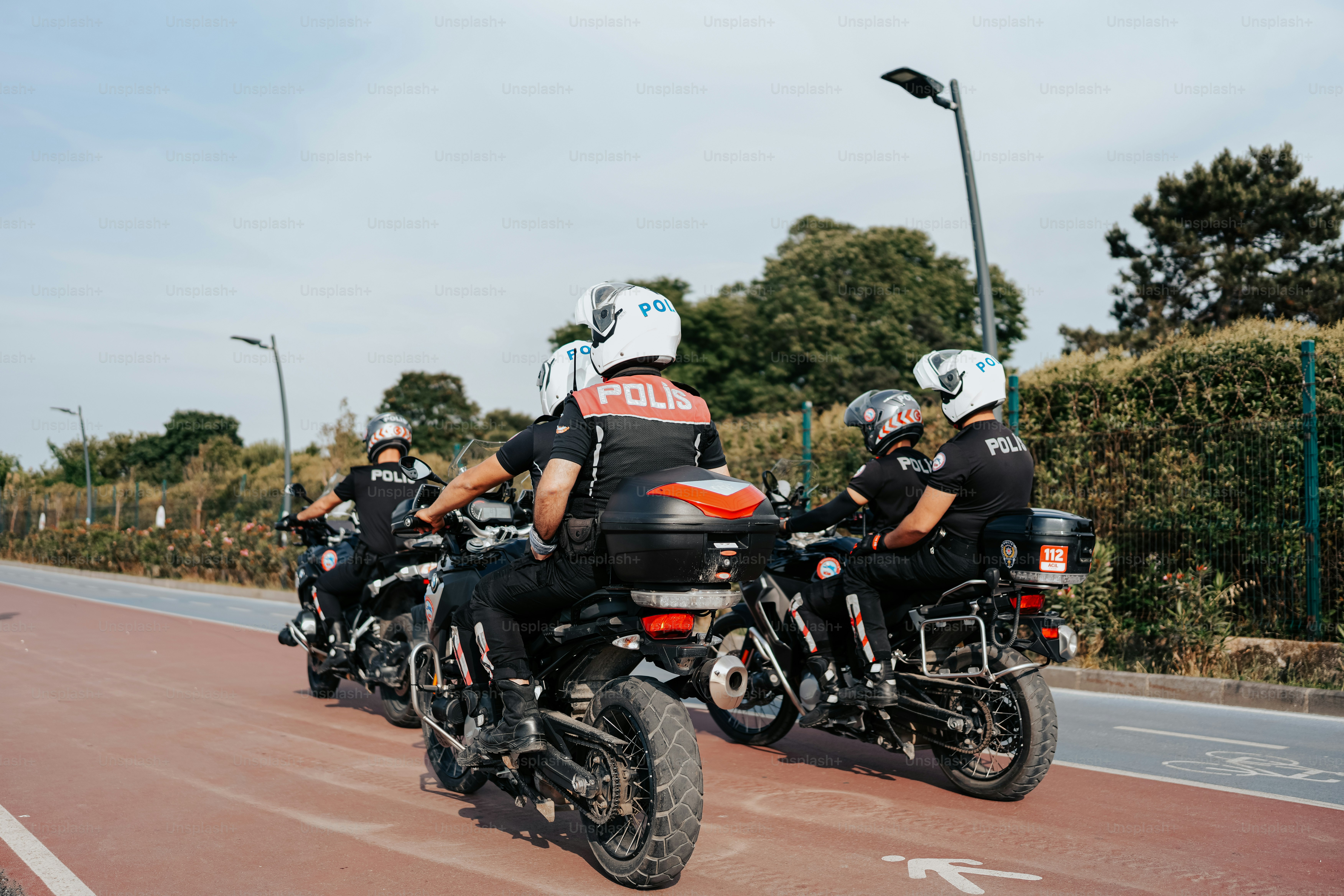 a group of people riding motorcycles down a street