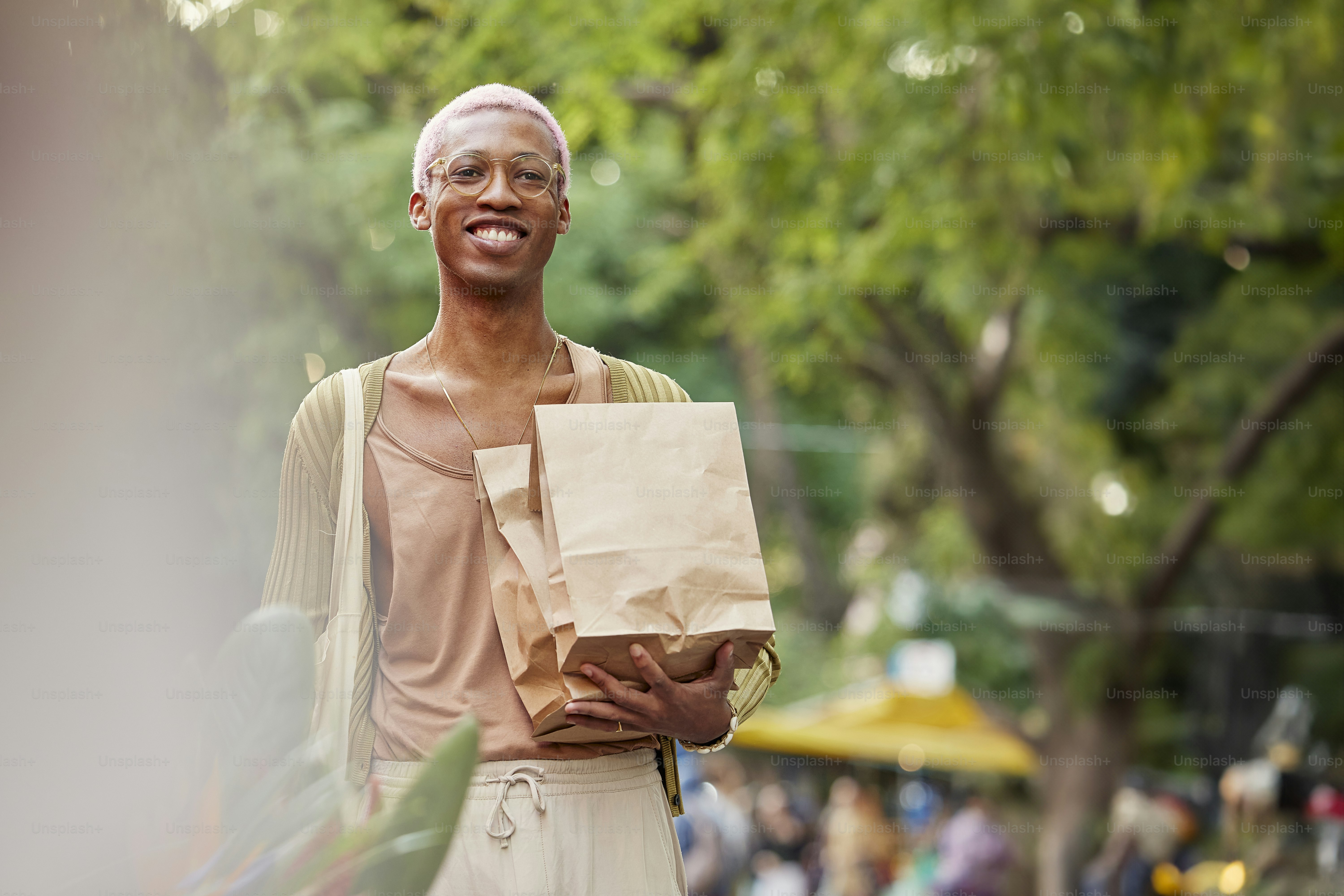 A man holding a brown paper bag and a brown paper bag photo