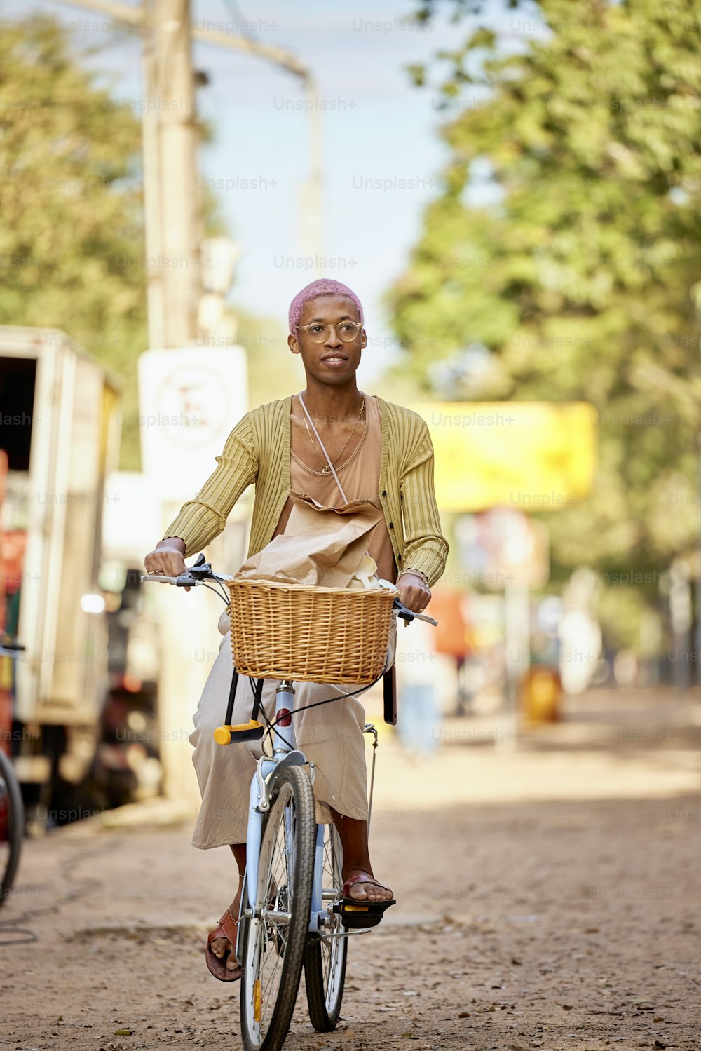 Un uomo che guida una bicicletta lungo una strada sterrata