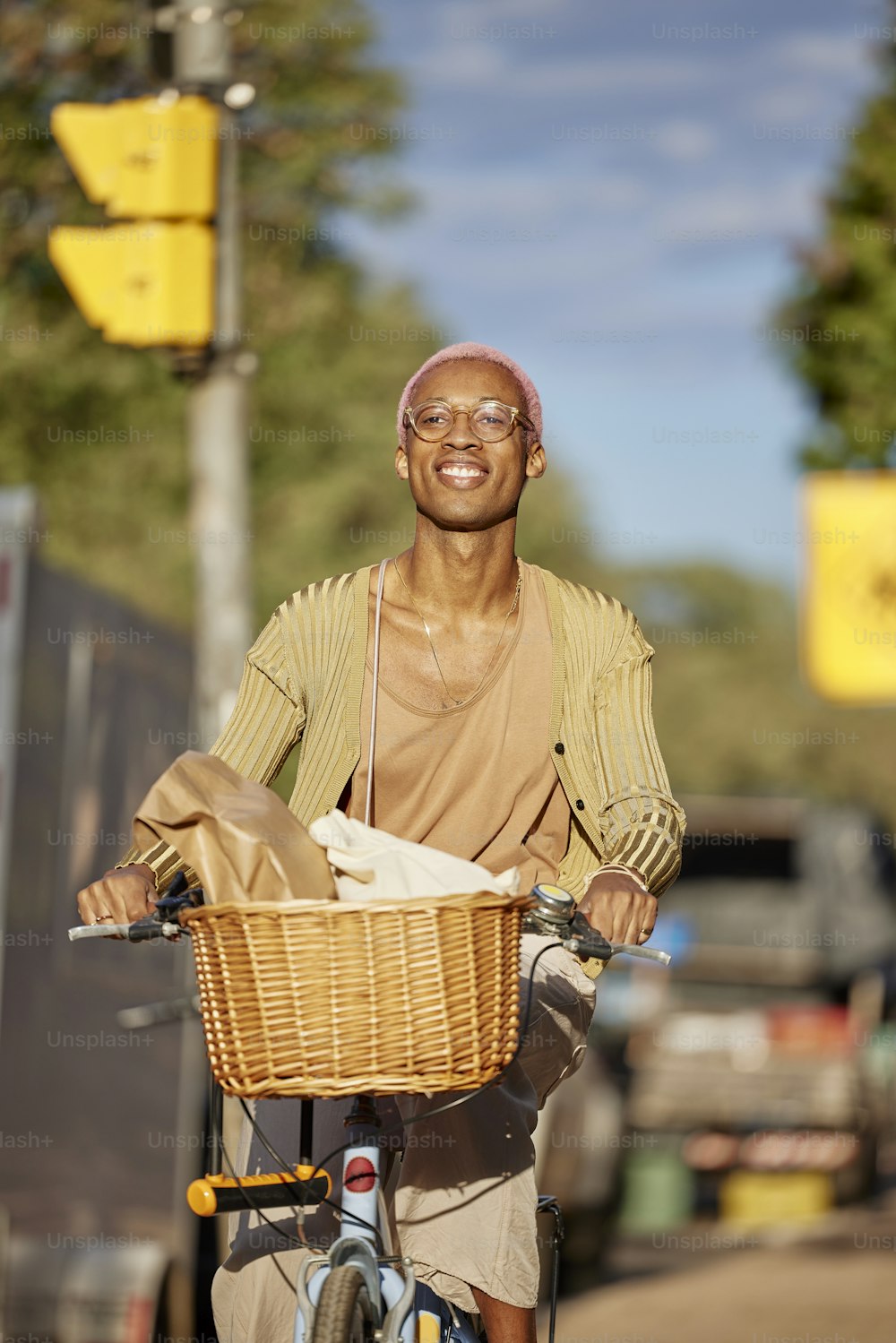 a man riding a bike down a street next to a traffic light