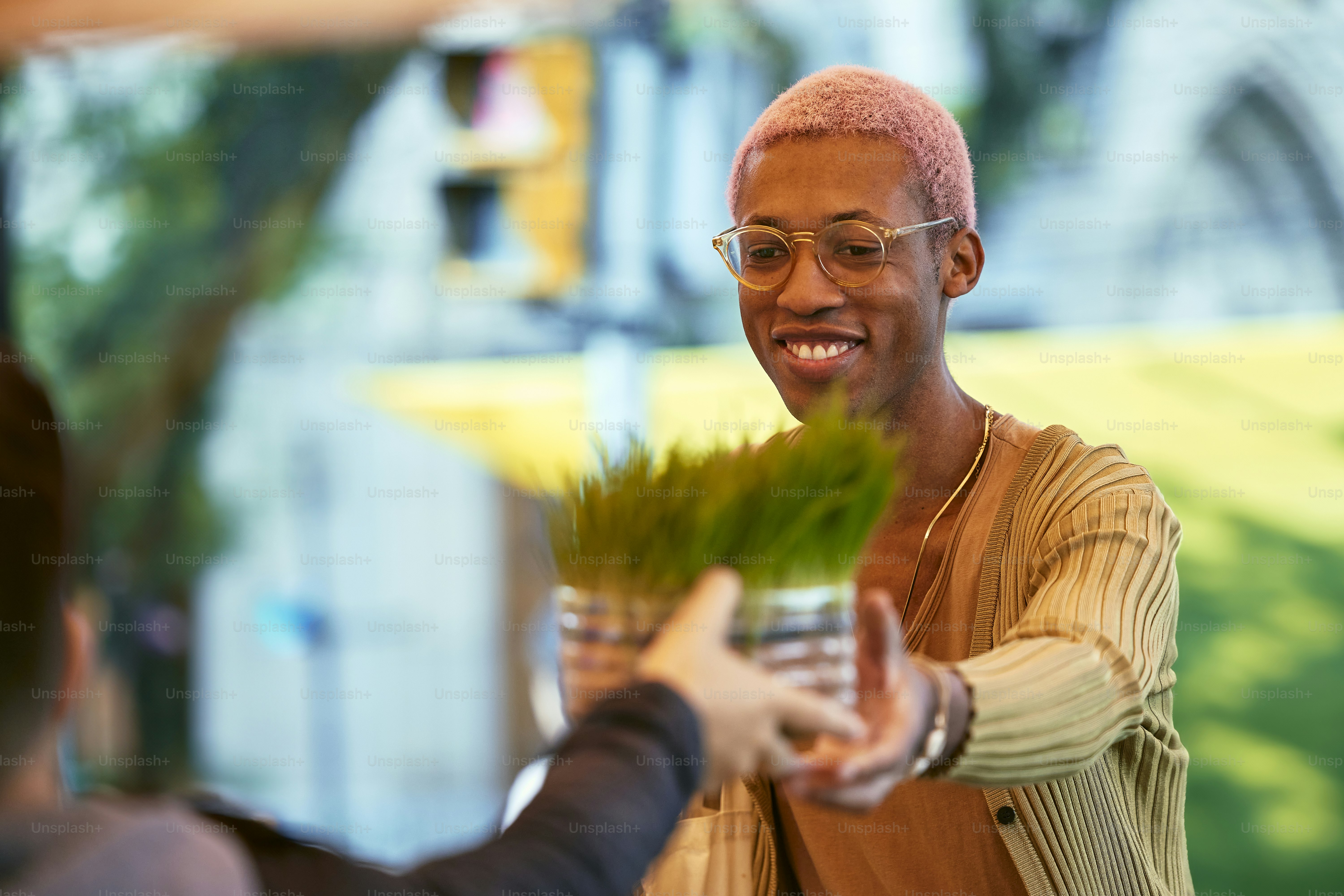 a man holding a plant in his hand