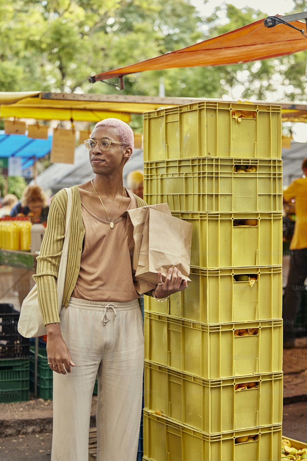 a man standing next to a yellow crate