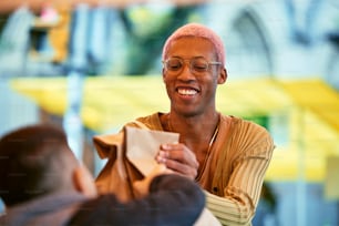 a man smiling while holding a piece of paper