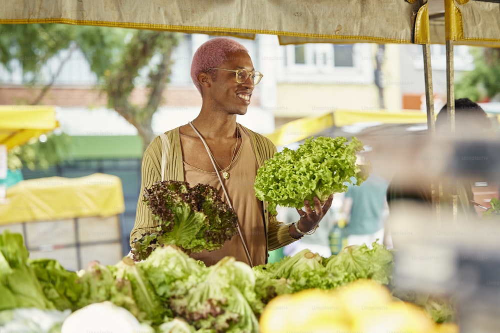 a man holding a bunch of lettuce in his hands