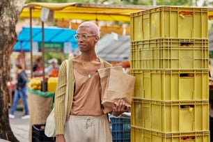 a man standing next to a yellow crate