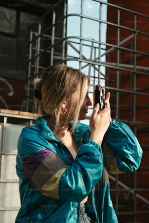 a woman holding a cell phone up to her ear