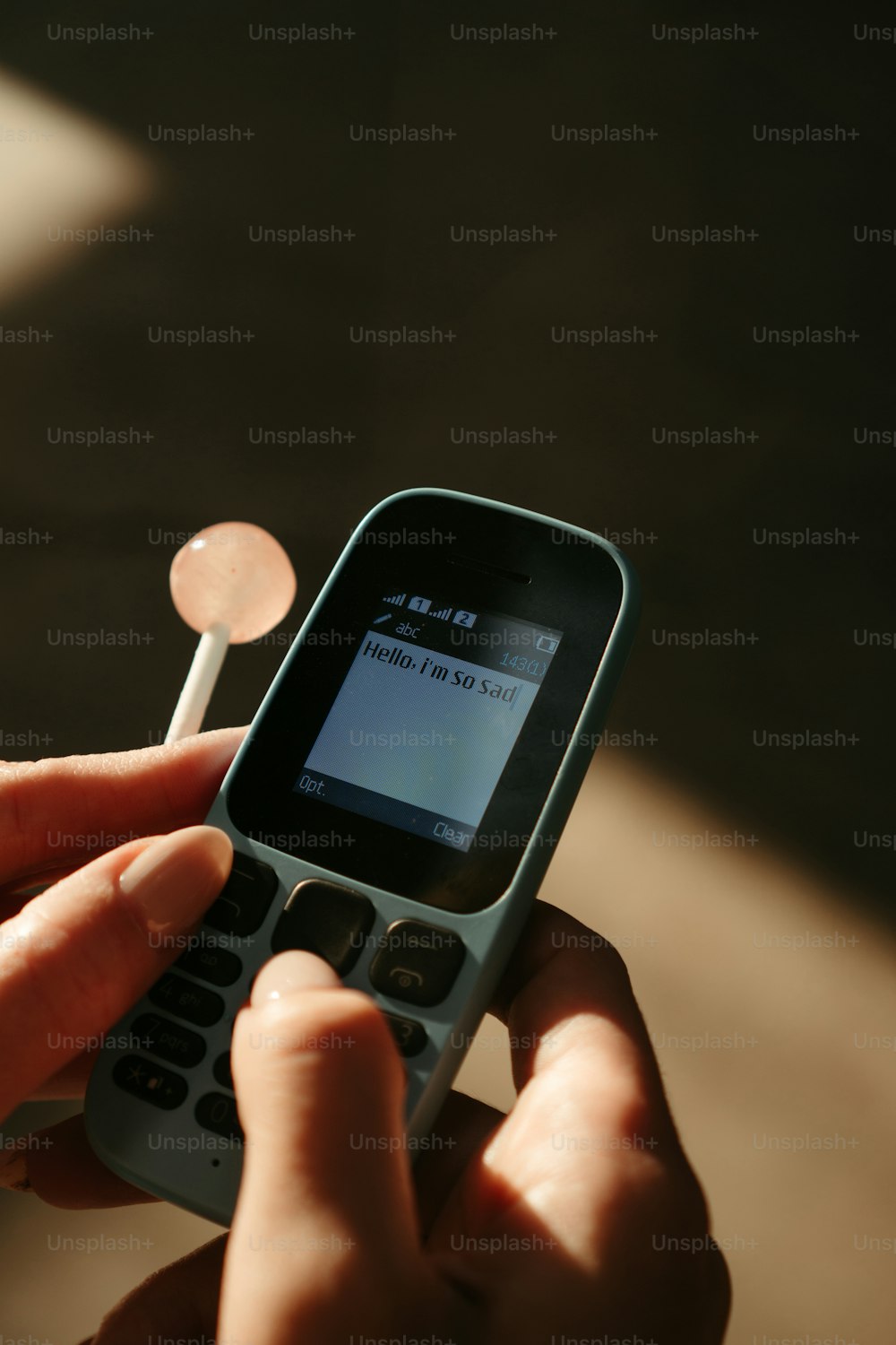 a person holding a cell phone in their hand