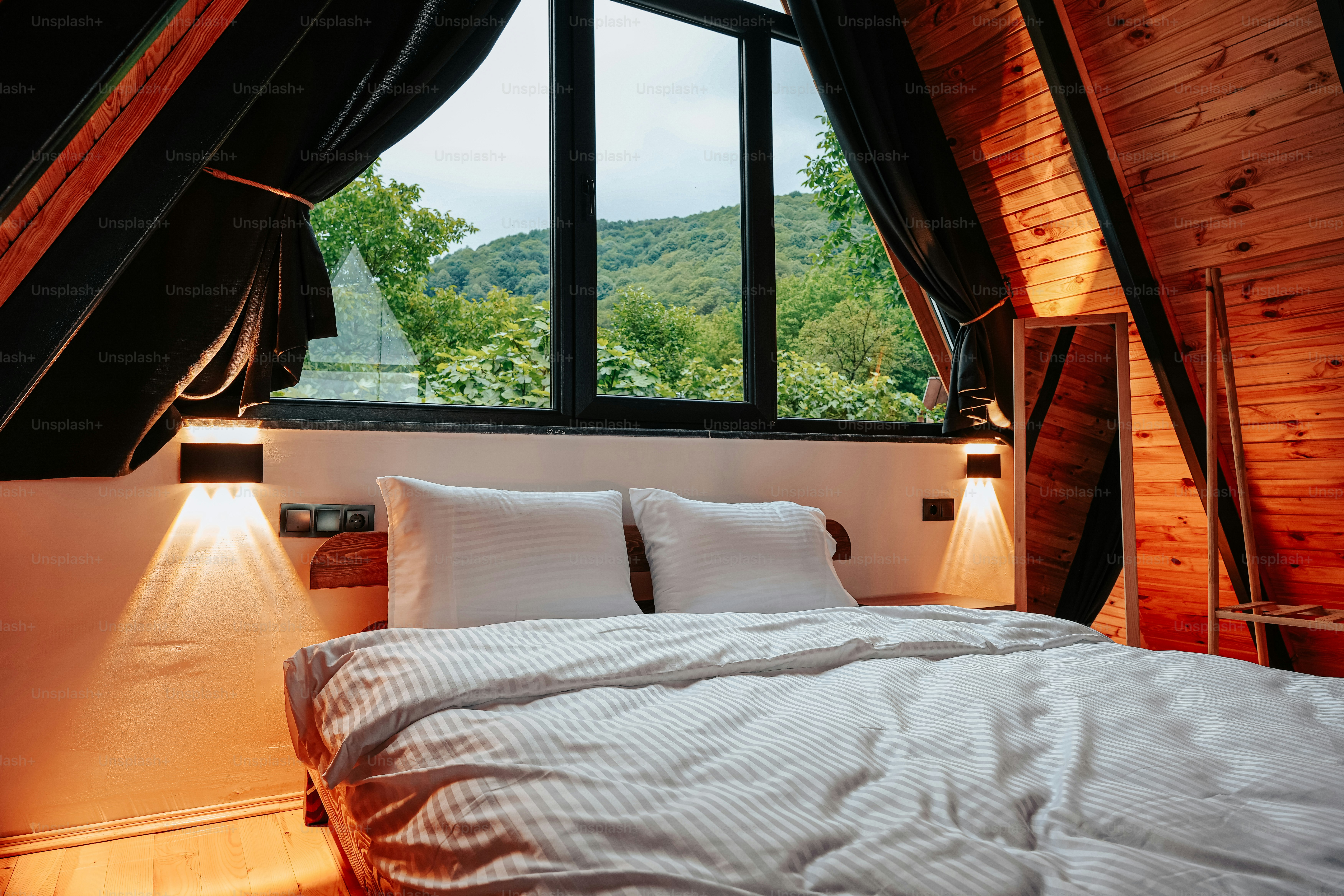 a bed sitting under a window in a bedroom