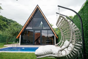 a large white hammock sitting next to a swimming pool