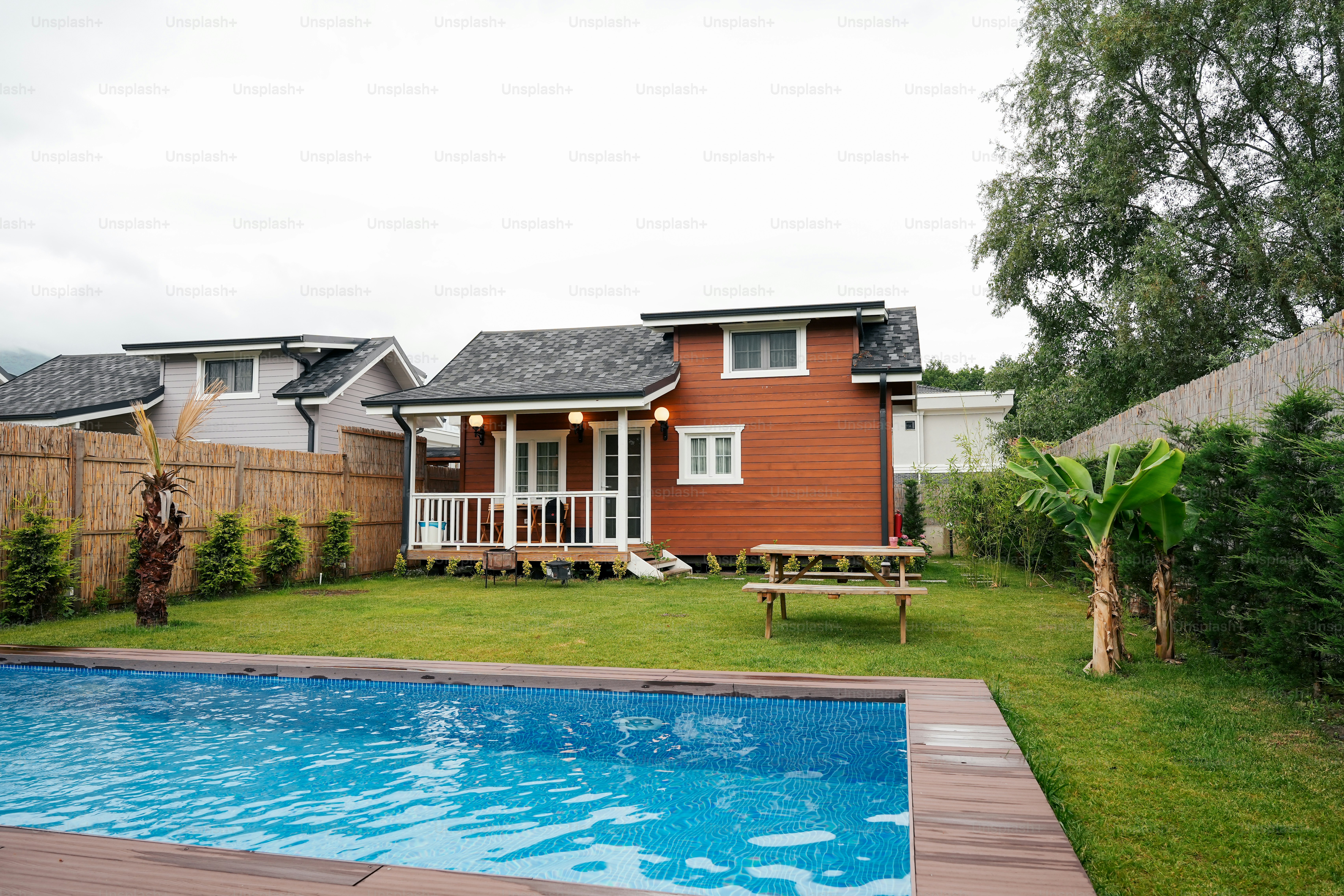 a backyard with a pool and a house