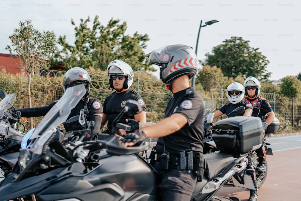 a group of men riding on the back of motorcycles