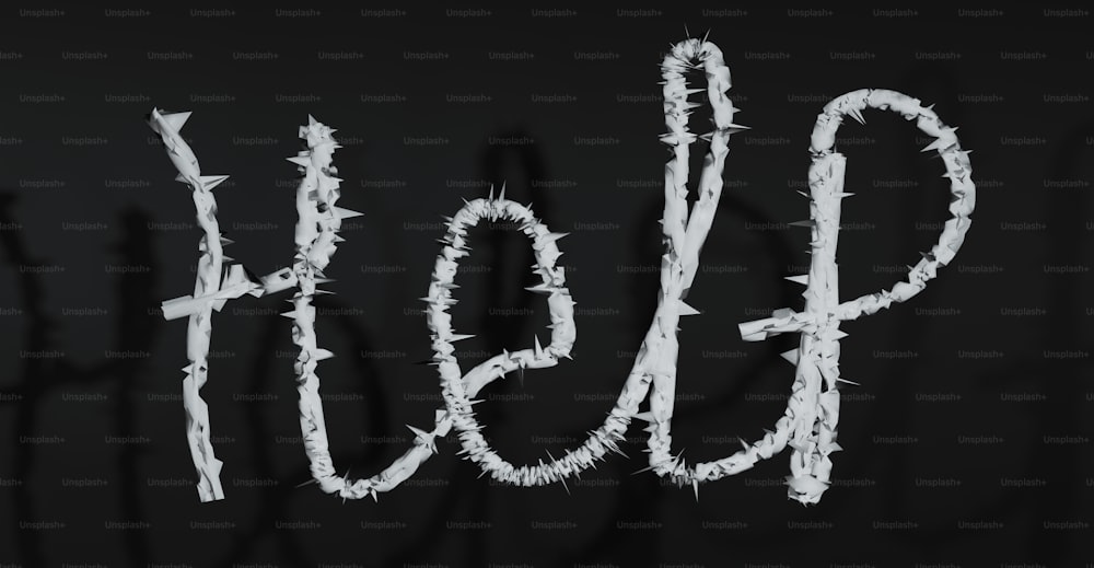 a black and white photo of the word hope written in barbed wire