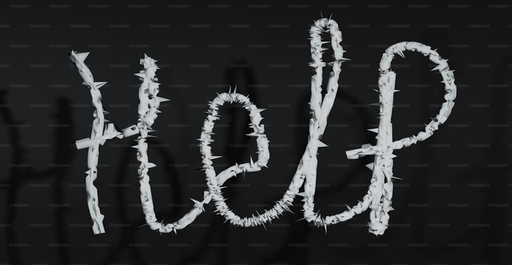 a black and white photo of the word hope written in barbed wire