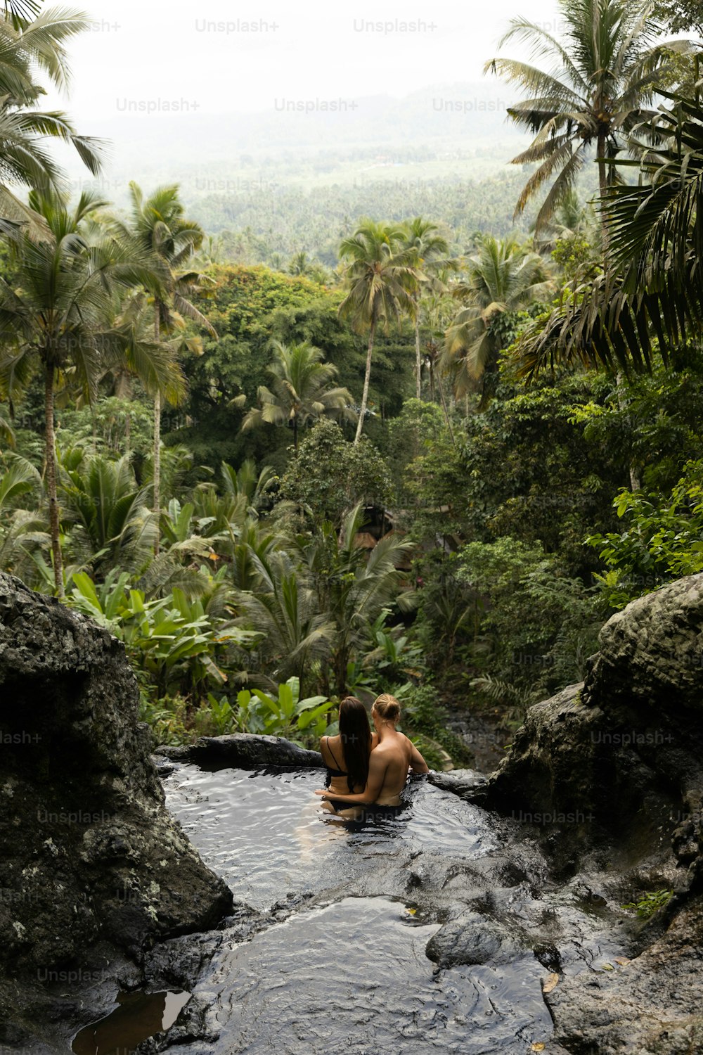 a man and a woman are sitting in a river