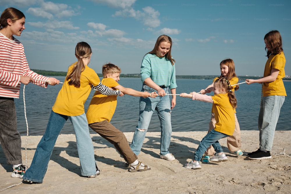 a group of young children playing tug of war