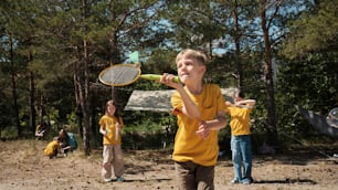 a group of young children playing a game of badminton