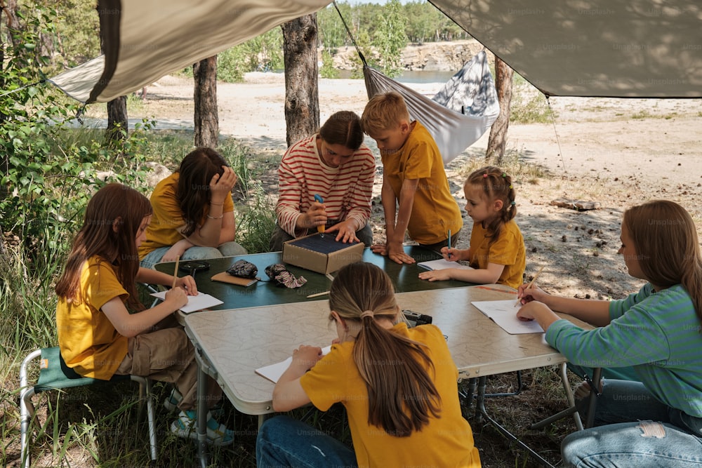 a group of children sitting around a table